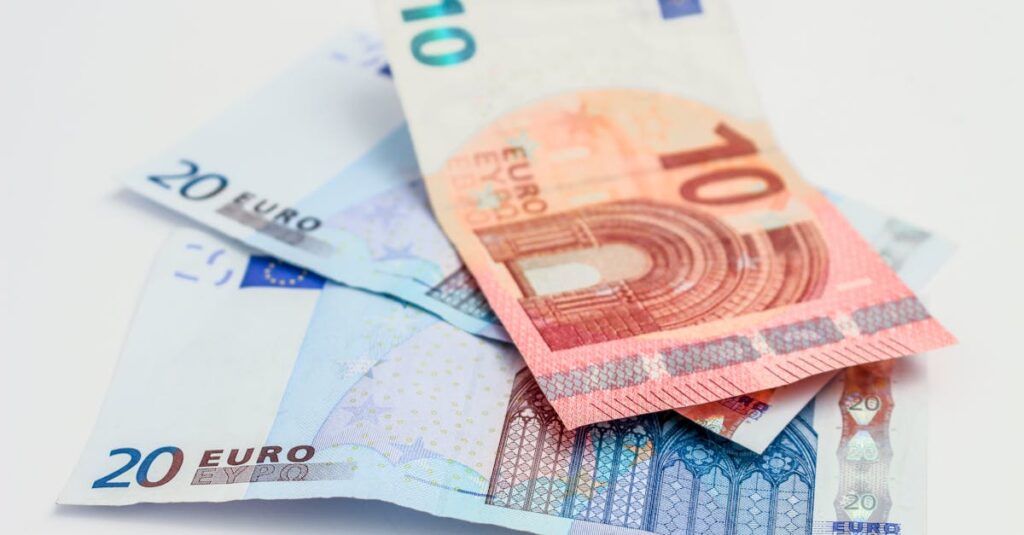 Stack of 10 and 20 euro banknotes symbolizing finance and economy.